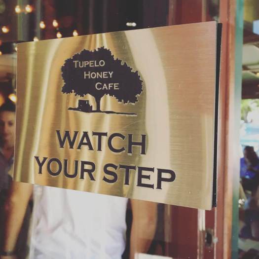 Brass Sign for a Café Saying WATCH YOUR STEP