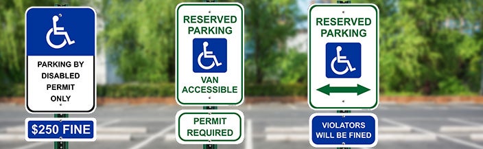Various Handicap Parking Signs With Wheelchair Symbols Posted In A Parking Lot 