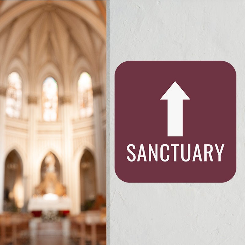 Custom aluminum directional sign pointing to a sanctuary