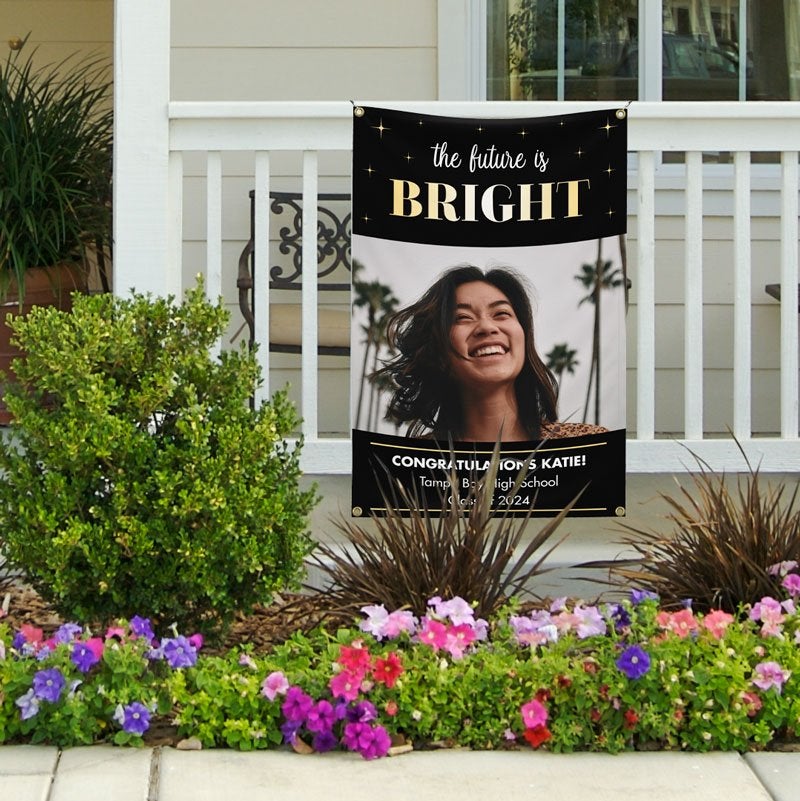 The Future Is Bright Graduation Banner Hanging On A Railing With A Female Student's Photo