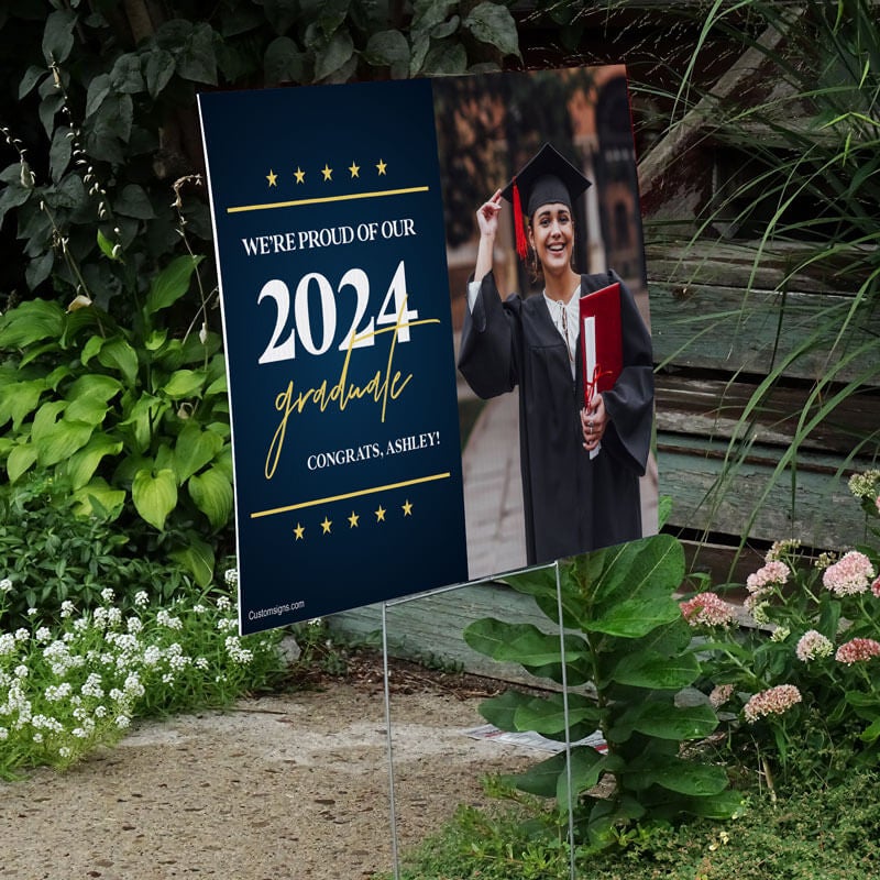 Star and Script custom graduation yard sign displayed by a pathway leading to stairs