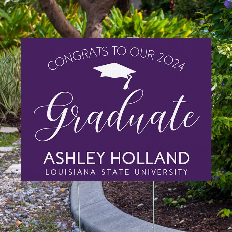 Congrats to our graduate yard sign displayed next to pavement