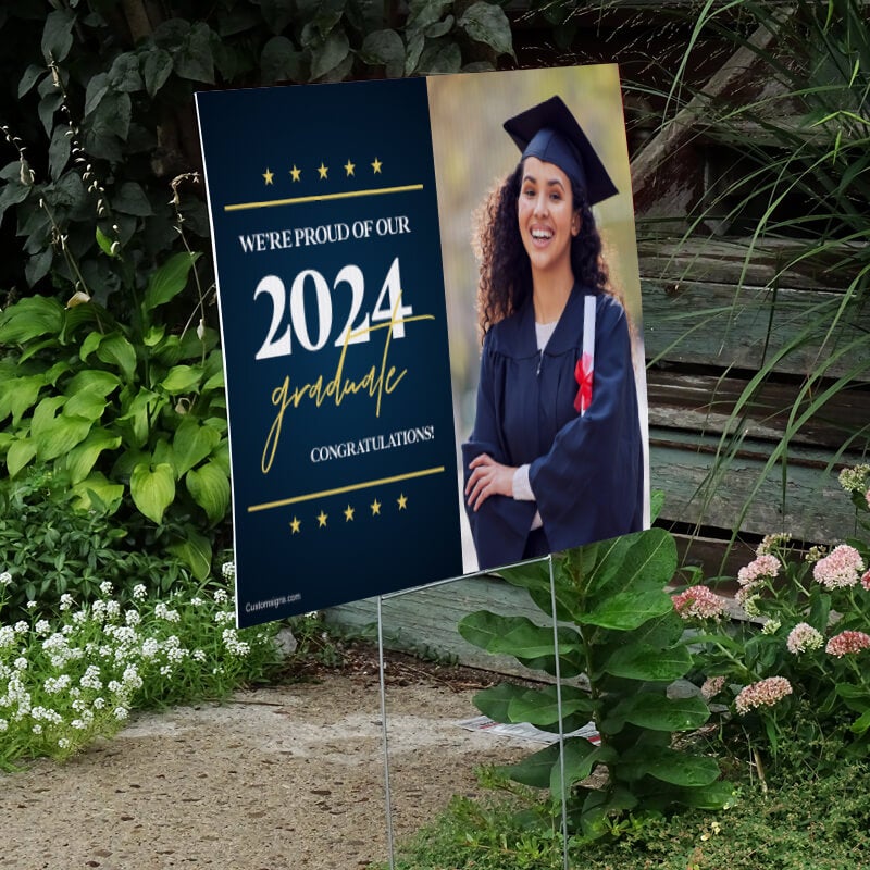 Star and Script graduation yard sign next to stairs