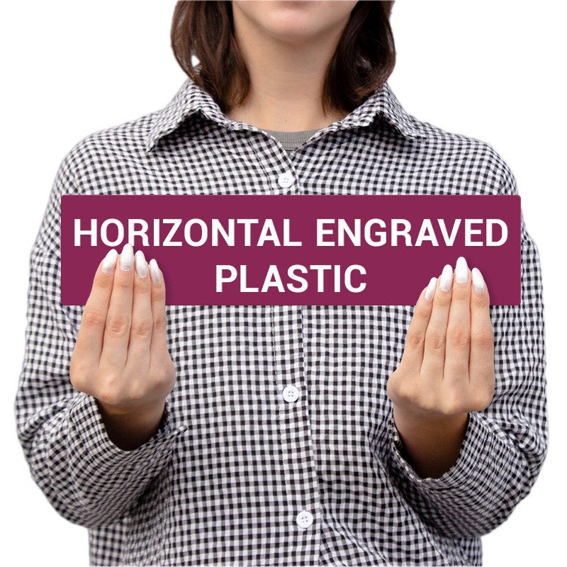 Person Holding A Horizontal Engraved Plastic Sign