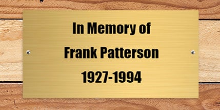 Custom engraved brass plaque engraved with a name and date as a memorial plaque