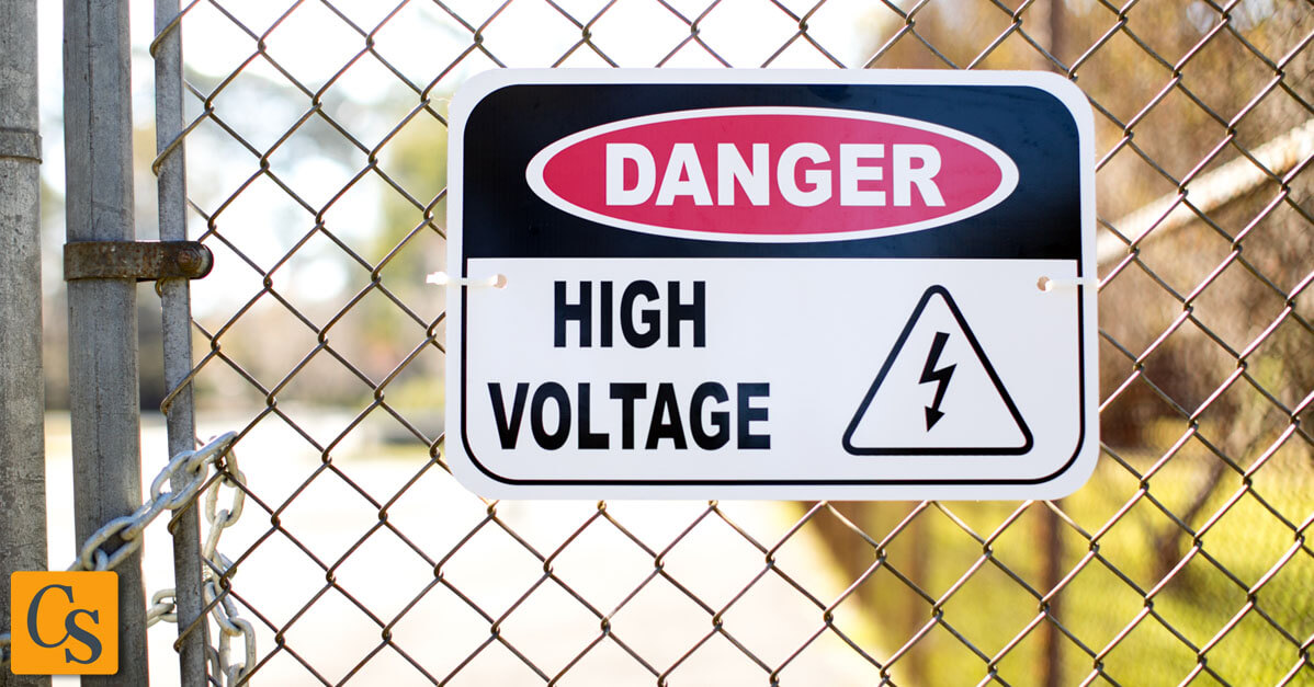 High Voltage Danger Sign Attached to a Chain Link Fence