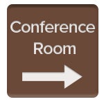 Brown plastic sign with Conference Room engraved in white letters and an arrow pointing to the right