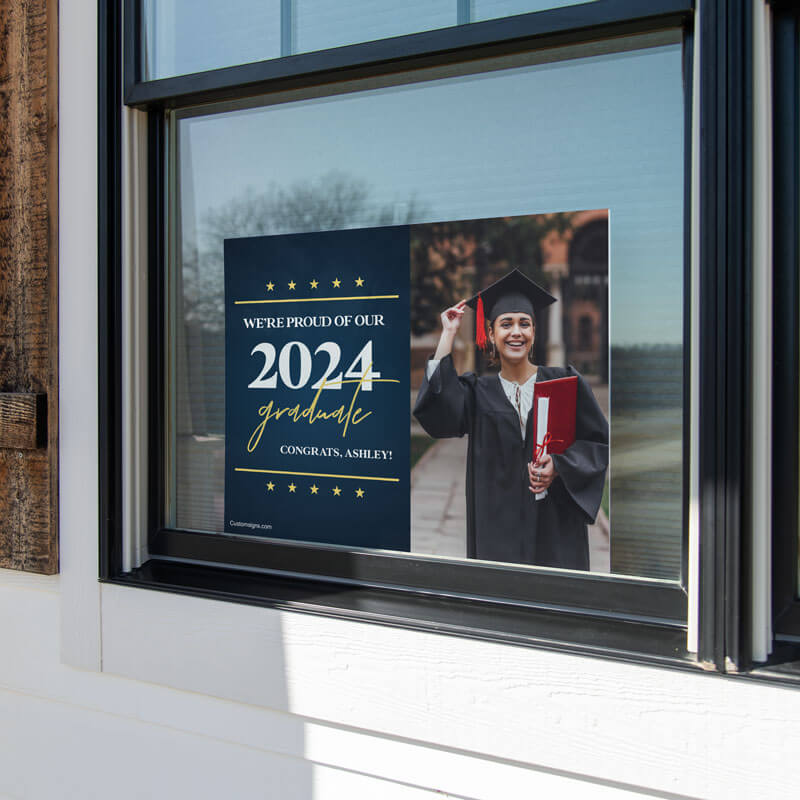 Star and Script custom graduation yard sign displayed in a window
