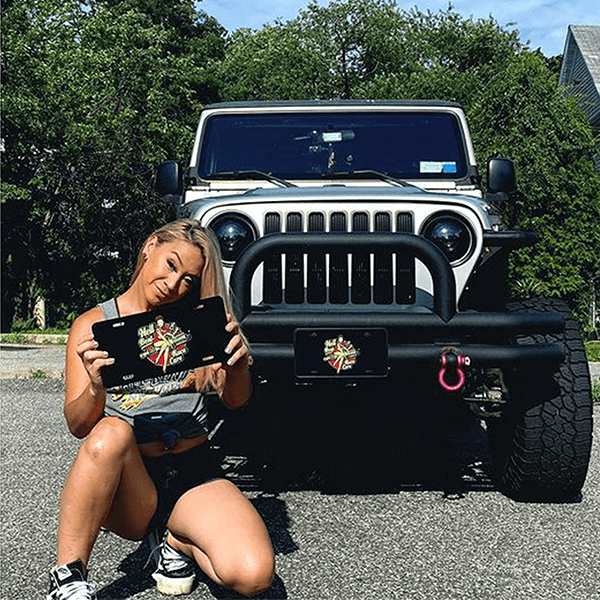 Girl with Custom License Plate in front of SUV